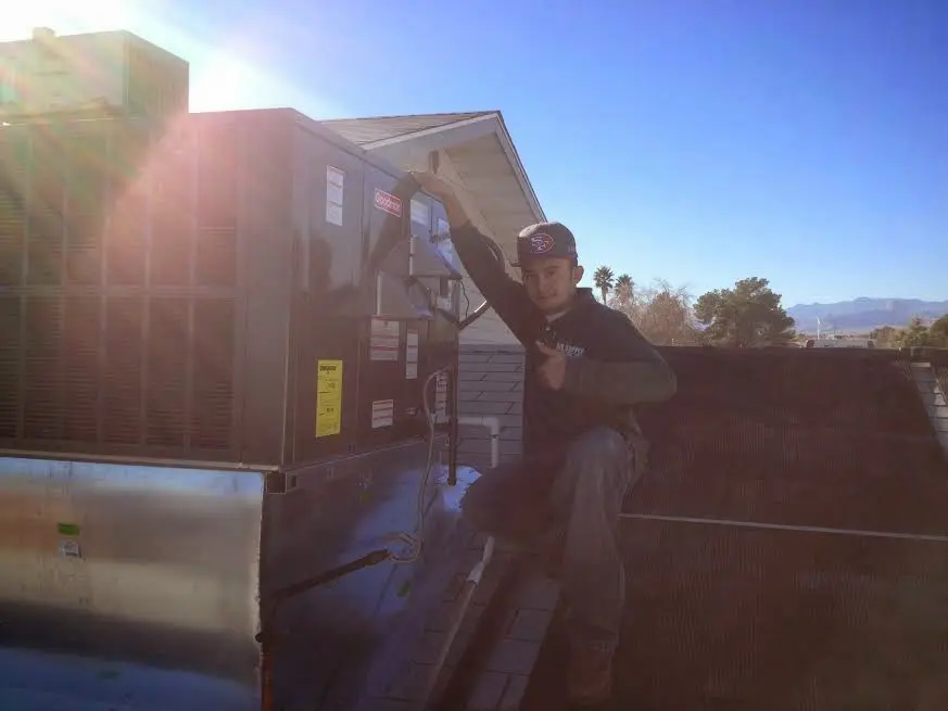 HVAC technician performing Boiler Repair on a rooftop unit in North Laurel